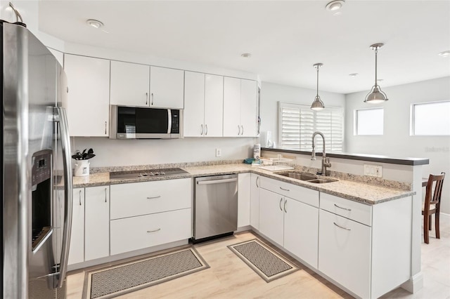 kitchen with white cabinetry, sink, and stainless steel appliances