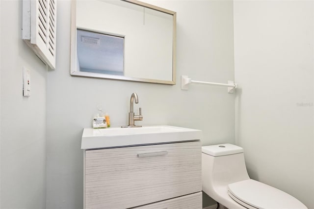 bathroom featuring vanity and toilet