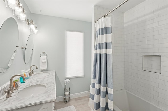 bathroom featuring hardwood / wood-style floors, vanity, and shower / bath combo