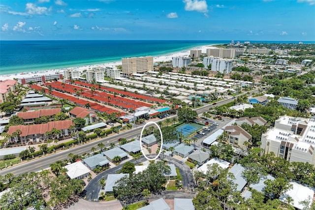 drone / aerial view with a water view and a beach view