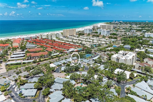 birds eye view of property featuring a beach view and a water view