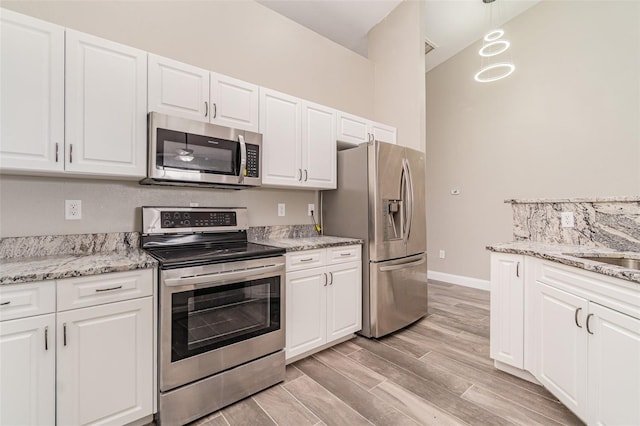 kitchen with white cabinetry and stainless steel appliances