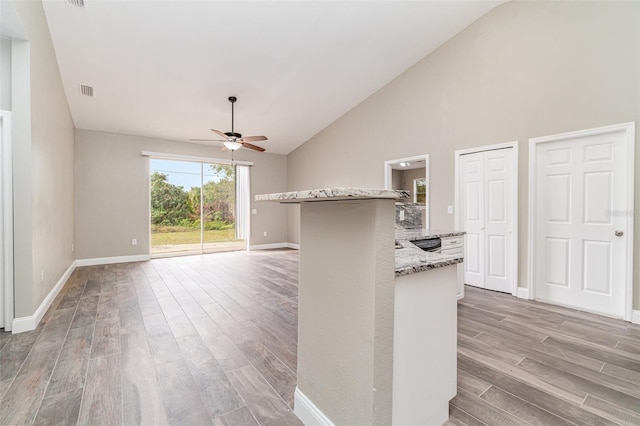 unfurnished living room featuring ceiling fan, high vaulted ceiling, and light hardwood / wood-style floors