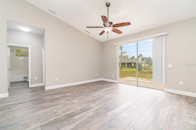 unfurnished room with plenty of natural light, lofted ceiling, and light wood-type flooring