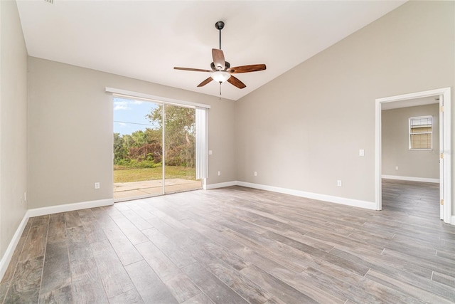 spare room with lofted ceiling, ceiling fan, and light wood-type flooring