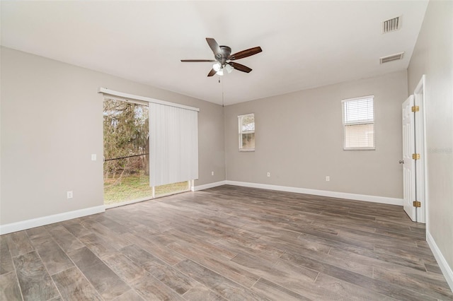 empty room with a wealth of natural light and ceiling fan