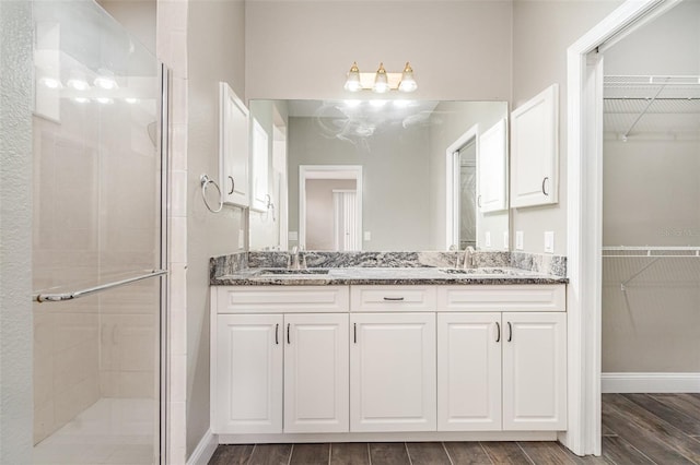 bathroom with vanity and an enclosed shower