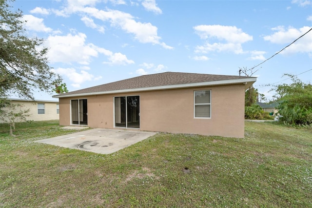 back of property featuring a patio area and a yard