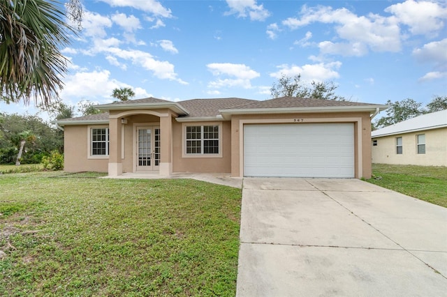 view of front facade with a front yard, french doors, and a garage