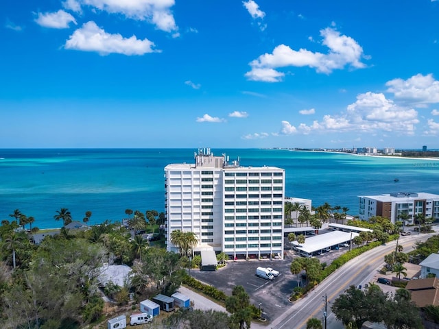 birds eye view of property featuring a water view and a view of city