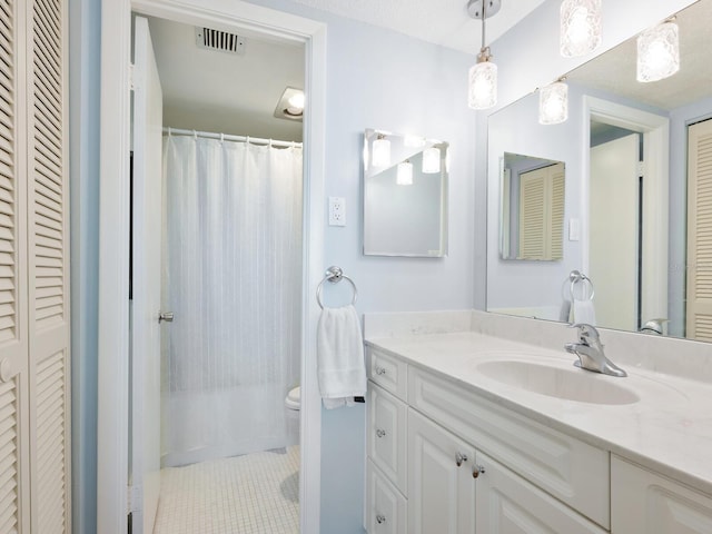 full bathroom featuring visible vents, toilet, tile patterned flooring, vanity, and a closet