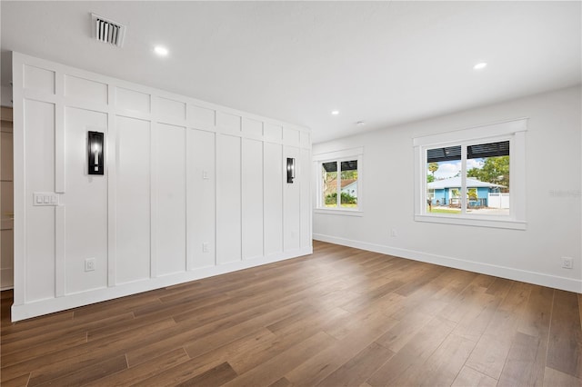 unfurnished bedroom with dark hardwood / wood-style flooring