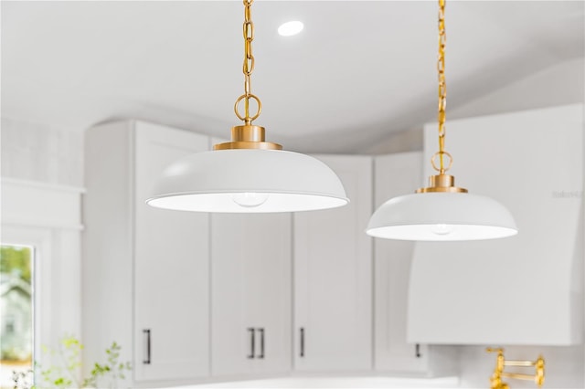 details featuring white cabinets and hanging light fixtures