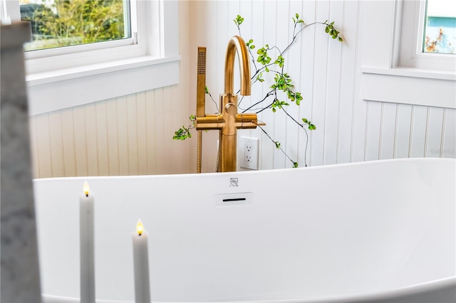 room details featuring a tub to relax in