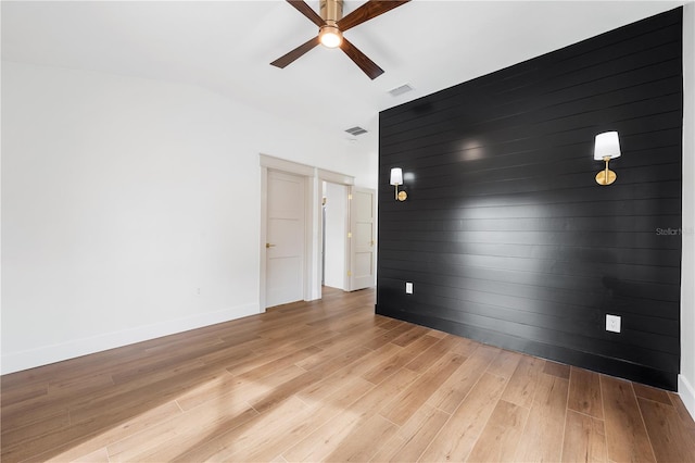 spare room featuring ceiling fan and light hardwood / wood-style flooring