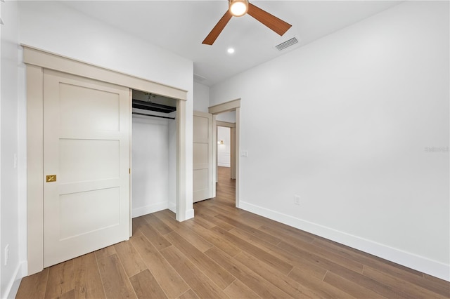 unfurnished bedroom featuring a closet, ceiling fan, and light wood-type flooring