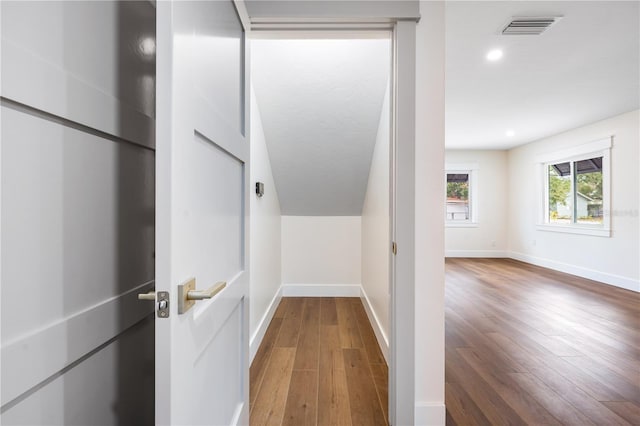 hallway with hardwood / wood-style flooring