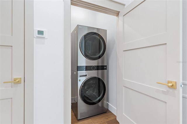 washroom featuring stacked washer and dryer and light hardwood / wood-style floors