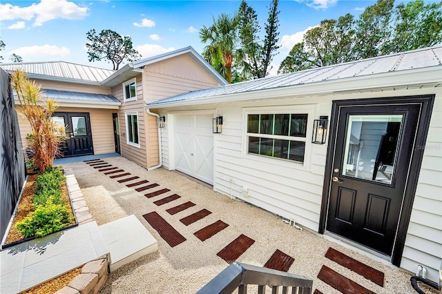 entrance to property with a porch and a garage