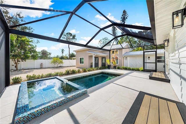 view of pool with a lanai, a patio, and an outbuilding