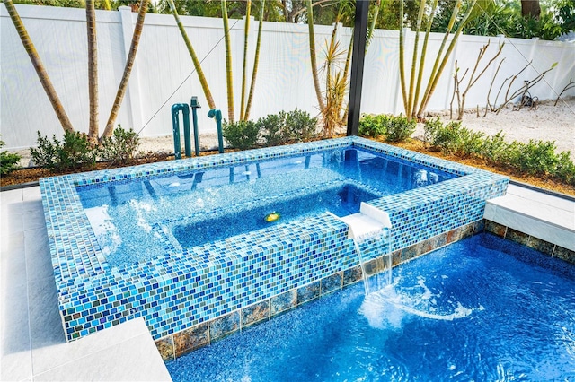 view of swimming pool with a hot tub