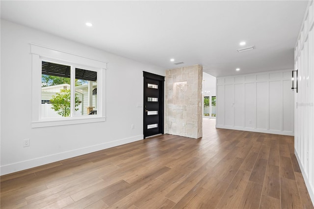 foyer featuring recessed lighting, wood finished floors, and baseboards