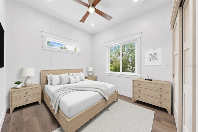 bedroom featuring baseboards, wood finished floors, a ceiling fan, and recessed lighting