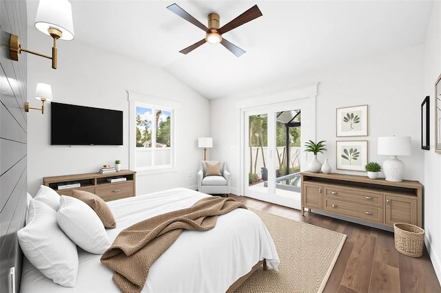 bedroom with baseboards, a ceiling fan, dark wood-type flooring, access to exterior, and vaulted ceiling