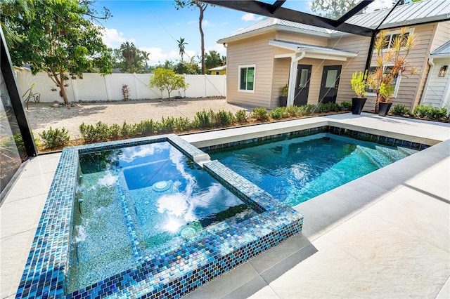 view of pool with glass enclosure, a swimming pool, a patio area, and a fenced backyard