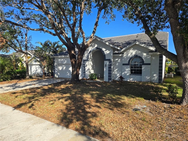 single story home with a front yard and a garage