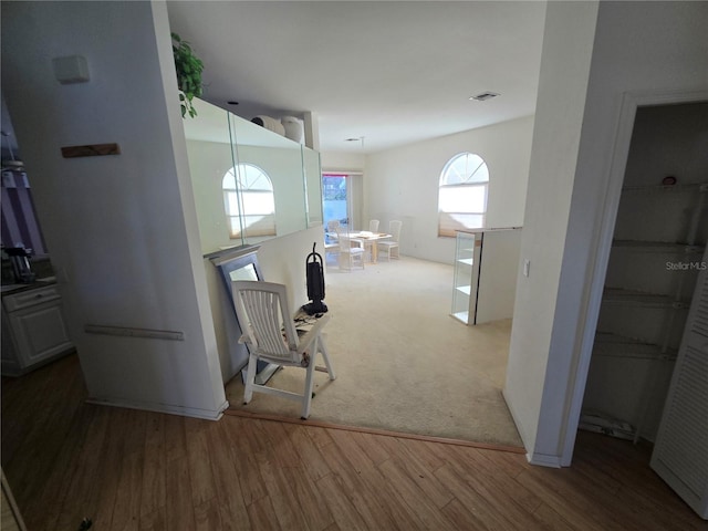 corridor with hardwood / wood-style floors