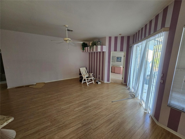 unfurnished living room featuring hardwood / wood-style floors and ceiling fan