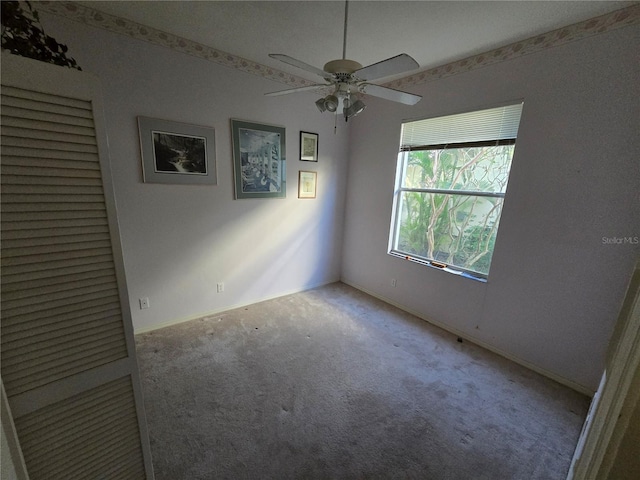 spare room featuring carpet flooring and ceiling fan