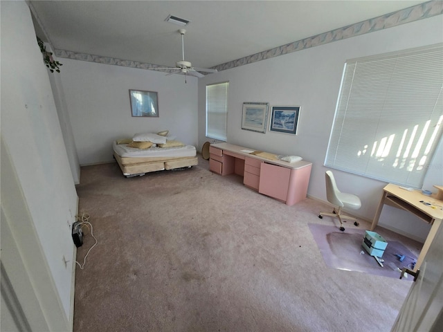 unfurnished bedroom featuring light colored carpet and ceiling fan