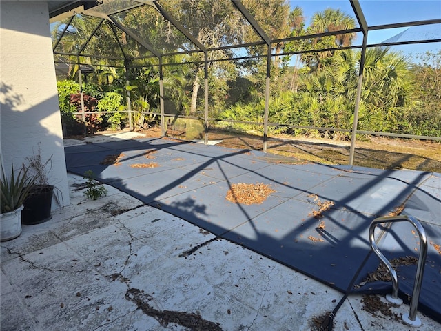 view of patio featuring glass enclosure