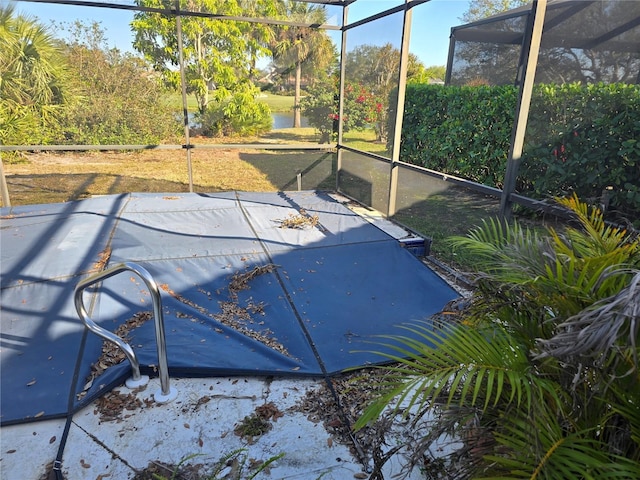 view of swimming pool featuring a lanai