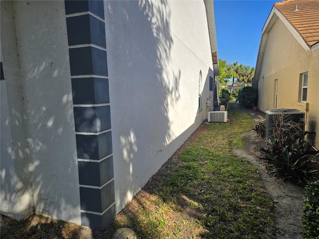 view of side of home featuring central AC unit