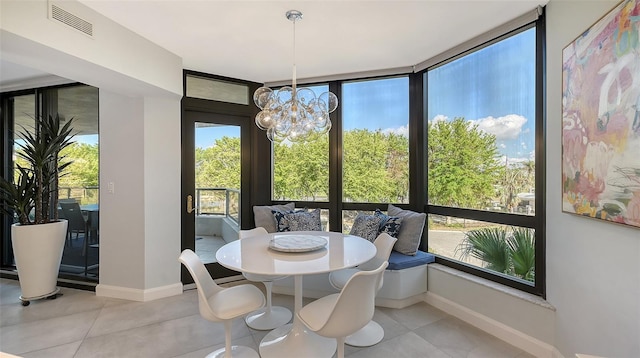 dining space with an inviting chandelier and expansive windows