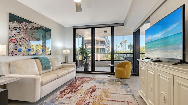 interior space with ceiling fan, expansive windows, and light tile patterned floors