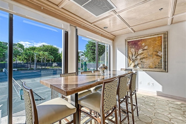 dining space featuring coffered ceiling