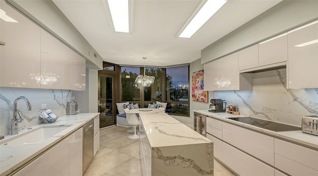 kitchen featuring black electric stovetop, white cabinets, decorative light fixtures, an inviting chandelier, and dishwasher