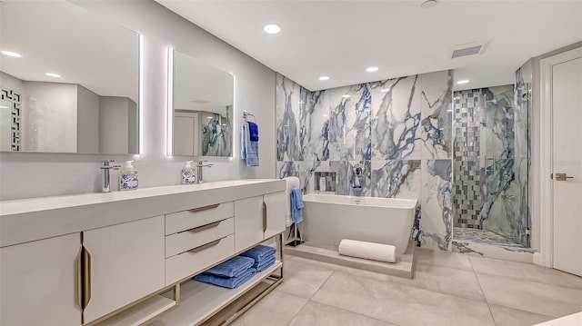 bathroom featuring tile patterned flooring, vanity, tile walls, and plus walk in shower