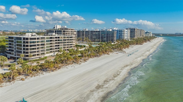 birds eye view of property with a beach view and a water view