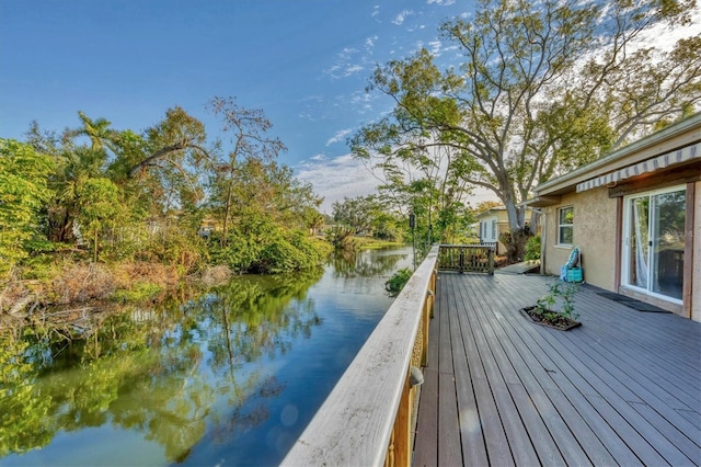 wooden terrace featuring a water view