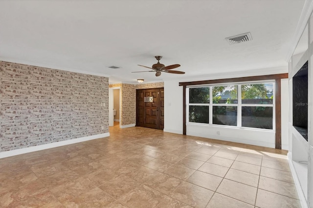 spare room with crown molding and ceiling fan