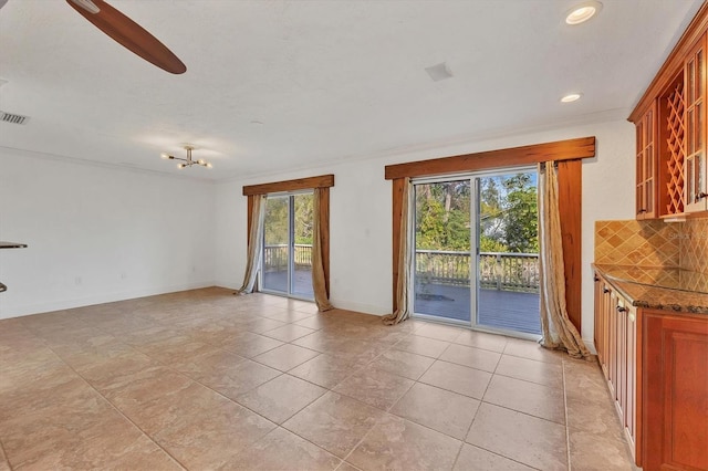 interior space with light tile patterned floors and ceiling fan