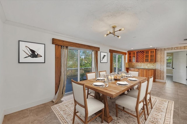 dining room featuring crown molding and a chandelier