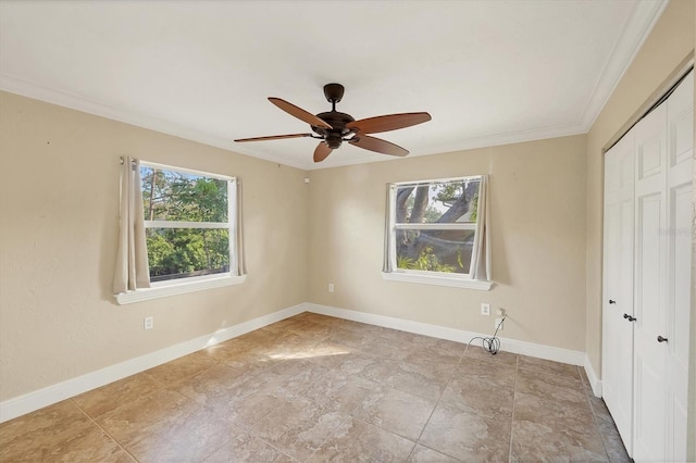 unfurnished bedroom with ornamental molding, ceiling fan, and a closet