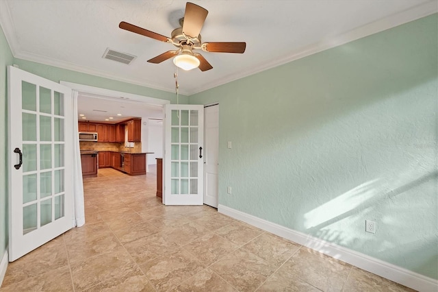 empty room featuring crown molding, ceiling fan, and french doors