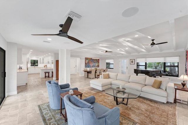 living room with vaulted ceiling with beams